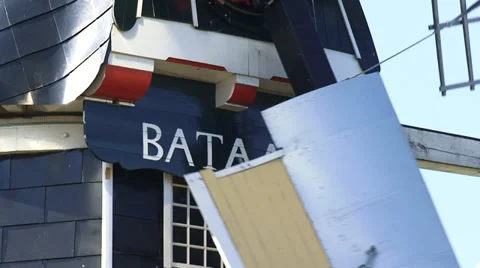 Close up Beard and name board windmill  with turning wicks against blue sky Stock Footage 34638269