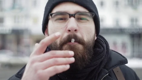 Close-up beard man smoking cigarette on camera Stock Footage 71982601