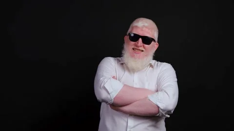 Close up of bearded man with albinism that is smiling on black background. Stock Footage 143589061