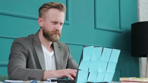 Close up of a bearded man comfortable at his desk, typing at the computer. Stock Footage 156338821