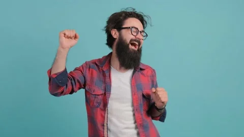 Close up of an bearded man dancing and posing over turquoise background. Stock Footage 141264868