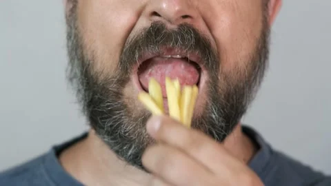 Close-up, bearded man eats, fast food, french fries. Stock Footage 134665061