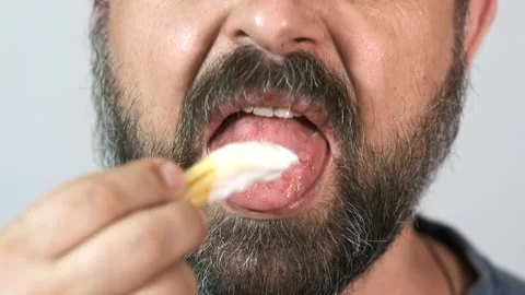 Close-up, bearded man eats fast food, french fries with mayonnaise. Stock Footage 143393536