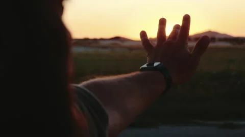 Close-up bearded man holds hand with smart watch out of car window driving along Stock Footage 172044449