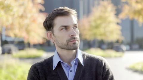 Close-up of a bearded man looking away thoughtfully outdoors, one person Stock-Footage 331819783