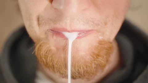 Close-Up of Bearded Man Spitting White Liquid After Rinsing Mouth for Oral Stock Footage 306446410