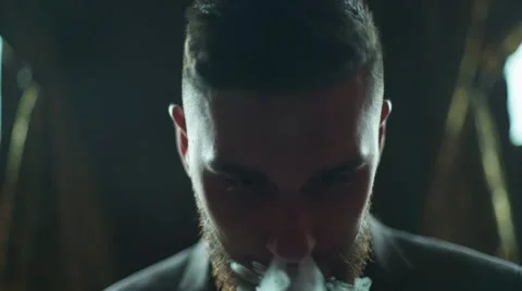 Close-up of a bearded man in suit smoking electronic cigarette Stock Footage 56899415