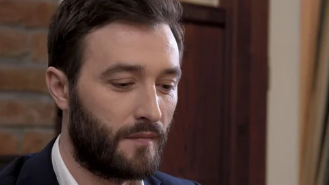 Close-up of bearded man in a suit tasting a glass of white wine. Stock Footage 89044283