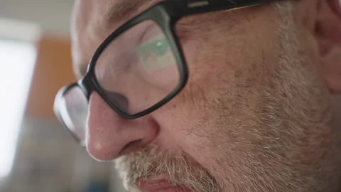 Close Up of Bearded Man’s Eyes Reading Computer Screen With Glasses Video stock 337767530