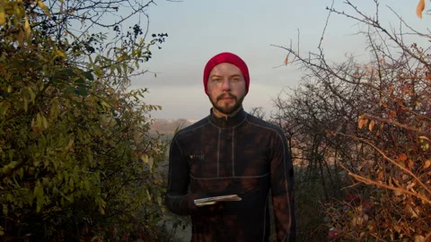 Close-up of bearded mid adult man looking at camera with serious look on his Video stock 166156053