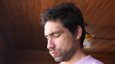 Close up of bearded white man looking down preparing something in daytime in 4k Stock Footage 199509592