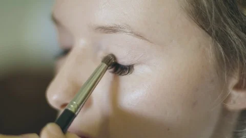 Close up of a  Beautician Making the Subtle Makeup for a Young Pretty Woman. Stock Footage