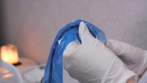 Close-up. The beautician prepares the machine for permanent makeup, puts a Stock-Footage 106892138