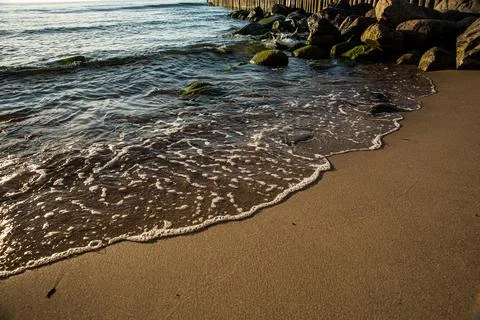 Close up of a beautiful beach with waves on soft sand Stock Photos