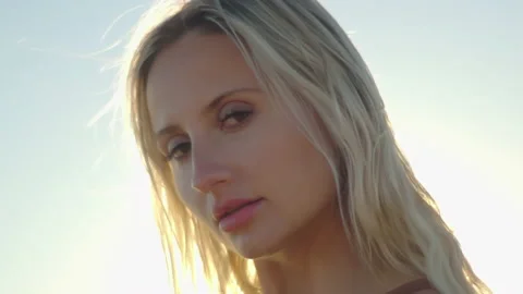Close up of  of a beautiful blonde at sunset on the ocean. Attractive Stock Footage 170135682