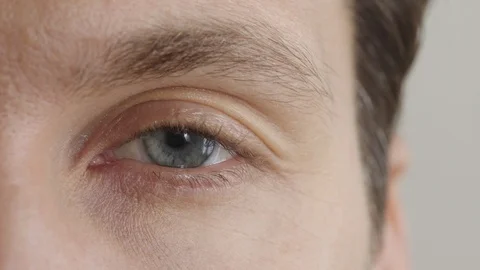 Close up beautiful blue eye blinking looking at camera iris pupil Stock Footage 92007250