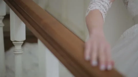 Close up of Beautiful Bride walking down stairs. Woman in white dress comes down Stock Footage 102266142