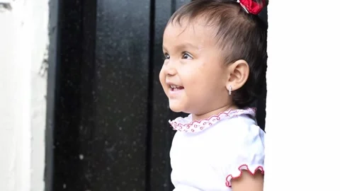 Close-up of a beautiful brown-skinned, very happy and smiling latina baby g.. Stock Footage 229720986