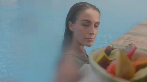Close-up of beautiful brunette in fruit basin Stock Footage 93539728