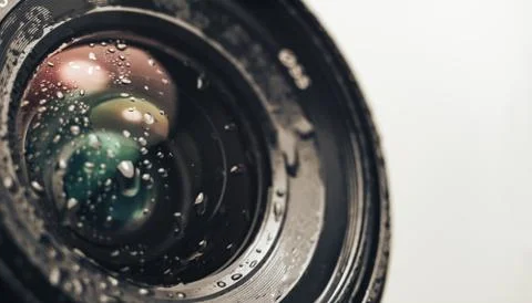 Close up beautiful Camera lens of drop water, on a white Background pattern f Stock Photos