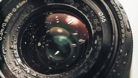 Close up beautiful Camera lens of drop water, white light. Background pattern Stock Photos