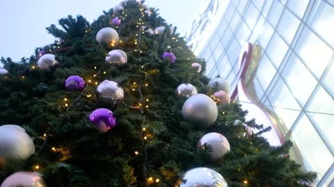 Close-up of a beautiful Christmas tree decorated with christmas balls on street Stock Footage 164884367