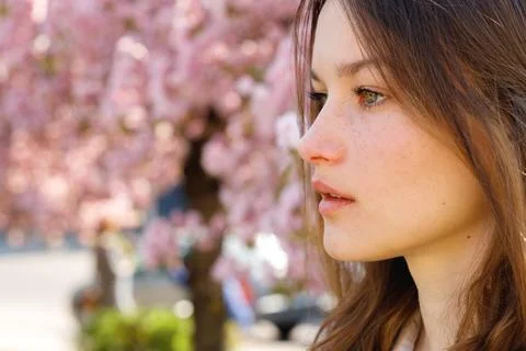 Close Up of the Beautiful Clean Face Posing Against Blooming Sakura Tree Outside Stock Photos