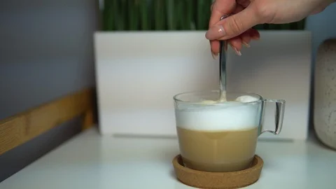 Close up of a beautiful coffee. Stirring with spoon. Stock Footage 104304503