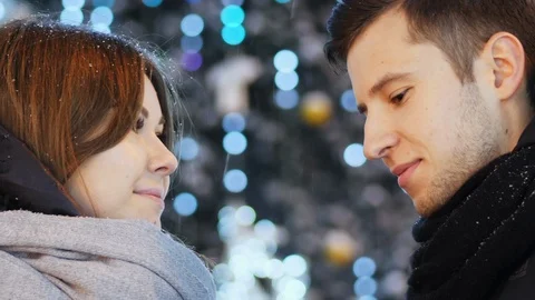 Close-up of Beautiful couple under the snowfall, New Year Christmas concept Video stock 100643674