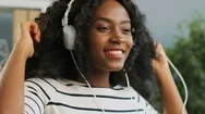 Close Up Of Beautiful Curly African American Young Woman In The White Headphones Stock Footage