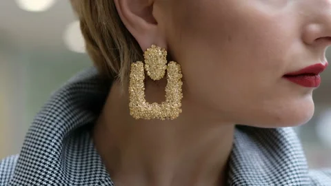 Close up of beautiful female earrings, while a woman turning her head Stock Footage 105366698