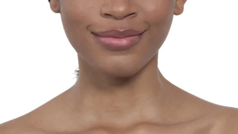 Close-up of a beautiful female model biting her lips. African woman is smiling Stock Footage 131399153