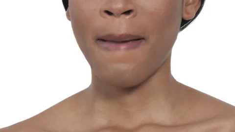 Close-up of a beautiful female model touching lips. Beauty concept. Isolated, on Stock Footage 131399604