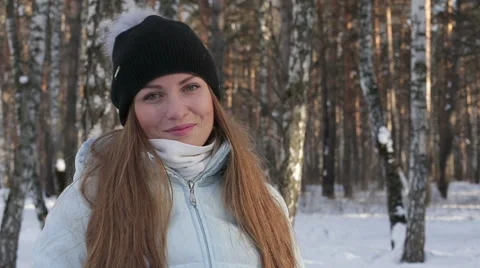 Close-up of beautiful girl smiling while looking at the camera in winter forest Stock Footage 61505385