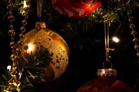 Close-up of beautiful gold and red Christmas ornaments hanging on a tree, c.. Stock Photos