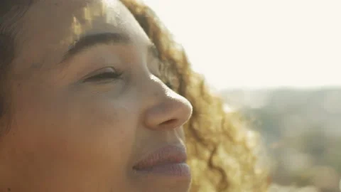 Close-up of beautiful inspiring woman looking at the sun Stock Footage
