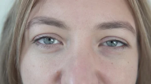 Close up the beautiful light eyes of a beautiful young woman Stock Footage 143471111