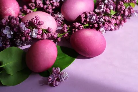 Close-up of beautiful lilac Easter eggs with blooming lilac branches. Easter 스톡 사진