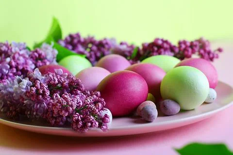 Close-up of beautiful lilac Easter eggs with blooming lilac branches. Easter 스톡 사진