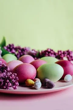 Close-up of beautiful lilac Easter eggs with blooming lilac branches. Easter 写真素材