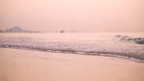 Close up of Beautiful ocean wave gliding on sandy tropical beach during sunset Stock Footage 318463152