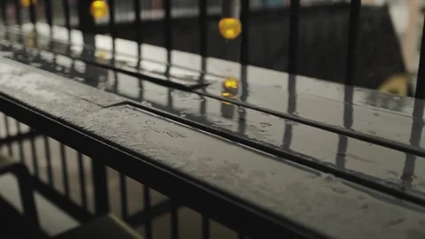 Close-up of beautiful raindrops floating on a shiny wooden surface, rain on the Stock Footage 315899280