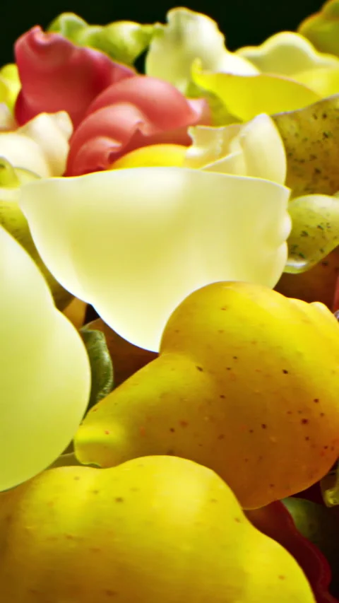 Close-up of beautiful small multicolored seashells lying un plate and rotating Stock Footage 285920396
