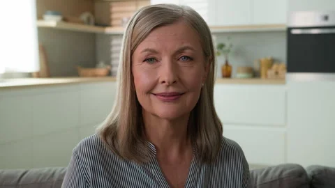 Close-up beautiful smiling elderly caucasian woman look camera at home confident Stock Footage 244665207