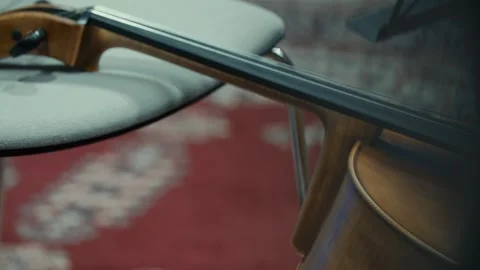 Close up of a beautiful violin resting against a chair, classical music, 4k Stock Footage 342938389