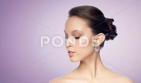 Close up of beautiful woman face with earring Stock Photos