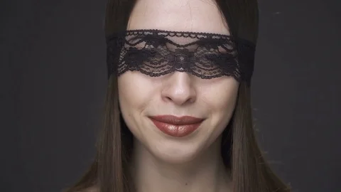 Close up beautiful woman's face in erotic lace headband smiling  Stock Footage 73116760