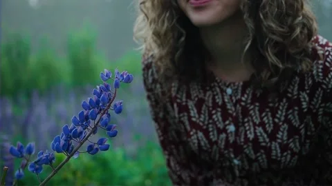 Close up. Beautiful young curly-haired lady with blue eyes in brown dress and Stock Footage 137745015