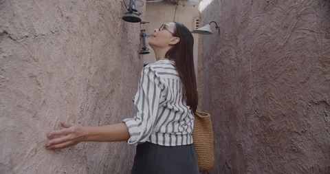 Close-up of beautiful young girl exploring the old Arabian streets of Dubai Stock Footage 126901694