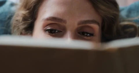 Close up of beautiful young lady reading exciting story, enjoying lazy morning Stock Footage 171675265